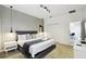 Modern bedroom featuring a plush bed, stylish lighting, and minimalist decor at 4367 Rhyme St, Kissimmee, FL 34746