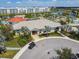 Aerial view of a clubhouse with lush landscaping, a golf cart, and community amenities at 4367 Rhyme St, Kissimmee, FL 34746