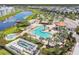 Aerial shot showcases a resort-style community pool with lush landscaping, a tiki bar, and lounge areas at 4367 Rhyme St, Kissimmee, FL 34746