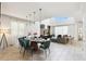 Bright dining room with modern decor featuring an oval wood table, 6 velvet chairs, and pendant lights over tiled floor at 4367 Rhyme St, Kissimmee, FL 34746
