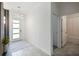 Bright foyer with a modern glass front door, designer light fixture, and bathroom access at 4367 Rhyme St, Kissimmee, FL 34746
