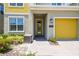 Inviting home entrance with brick pathway, yellow door, and a well-maintained front yard at 4367 Rhyme St, Kissimmee, FL 34746