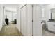 Hallway view with carpeted flooring, closet space, view of living room, and partial view of bathroom at 4367 Rhyme St, Kissimmee, FL 34746