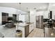 Modern kitchen with large island, stainless appliances, and seamless connection to the living area at 4367 Rhyme St, Kissimmee, FL 34746