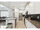Open-concept kitchen featuring a large island, stainless appliances, and modern white cabinetry at 4367 Rhyme St, Kissimmee, FL 34746