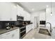 Well-equipped kitchen featuring stainless steel appliances and dark backsplash at 4367 Rhyme St, Kissimmee, FL 34746