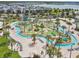 An aerial view showcases the community lazy river and splashpad along with miniature golf and nearby residences at 4367 Rhyme St, Kissimmee, FL 34746