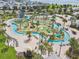 Aerial view of a community lazy river and splashpad complete with miniature golf and surrounding residences at 4367 Rhyme St, Kissimmee, FL 34746