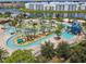 Aerial view of the lazy river and splashpad with a slide in a Primary-planned community by a lake at 4367 Rhyme St, Kissimmee, FL 34746