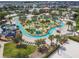 Aerial view of the lazy river and splash pad with palm trees and mini golf in a residential community at 4367 Rhyme St, Kissimmee, FL 34746