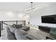Living room featuring modern lighting, television, comfortable seating, and railing at 4367 Rhyme St, Kissimmee, FL 34746