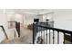 Open living room with carpet, railing, television, and modern decor at 4367 Rhyme St, Kissimmee, FL 34746