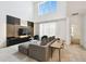 Bright living room featuring a gray sofa, statement wall with TV, and a large window with lots of natural light at 4367 Rhyme St, Kissimmee, FL 34746