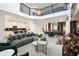 Open concept living space with black railings, connecting kitchen, dining, and living areas at 4367 Rhyme St, Kissimmee, FL 34746