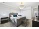Stylish main bedroom featuring a gray platform bed, modern lighting, and a neutral color palette at 4367 Rhyme St, Kissimmee, FL 34746
