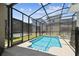 Backyard pool area with a screened enclosure showcasing a pool and surrounding patio at 4367 Rhyme St, Kissimmee, FL 34746