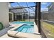Backyard pool and hot tub are within a screened enclosure at 4367 Rhyme St, Kissimmee, FL 34746