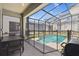 Screened pool area featuring outdoor dining table, grill, and -safety fencing at 4367 Rhyme St, Kissimmee, FL 34746