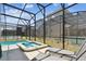 Screened pool area featuring a hot tub with lounge chairs for relaxation at 4367 Rhyme St, Kissimmee, FL 34746