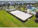 Aerial view of a sand volleyball court with manicured hedge rows in a well-maintained community at 4367 Rhyme St, Kissimmee, FL 34746