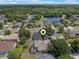 Expansive aerial view showcasing the property with a serene lake, lush greenery, and neighborhood setting at 5226 Smokey Water Ln, Oviedo, FL 32765