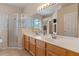 Bright bathroom with double vanities, glass shower, and updated fixtures at 5226 Smokey Water Ln, Oviedo, FL 32765