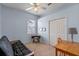 Bedroom with light blue walls, ceiling fan, large closet and minimalist decor at 5226 Smokey Water Ln, Oviedo, FL 32765