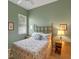 Bedroom with green walls, ceiling fan, floral accents, and warm lighting at 5226 Smokey Water Ln, Oviedo, FL 32765