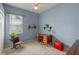 Bedroom with light blue walls, ceiling fan, and a desk with charming vintage decor at 5226 Smokey Water Ln, Oviedo, FL 32765