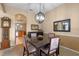 Inviting dining room featuring modern chandelier, and view of the open-concept kitchen at 5226 Smokey Water Ln, Oviedo, FL 32765