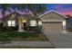 Charming single-Gathering home featuring a well-manicured lawn, mature landscaping, and a two-car garage at 5226 Smokey Water Ln, Oviedo, FL 32765