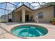 Outdoor hot tub on a screened in brick patio, perfect for relaxation at 5226 Smokey Water Ln, Oviedo, FL 32765