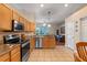 Bright kitchen features tile floors, stainless steel appliances, breakfast bar and modern lighting at 5226 Smokey Water Ln, Oviedo, FL 32765