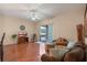 Comfortable living room with wood floors, ceiling fan, and sliding glass doors to the patio at 5226 Smokey Water Ln, Oviedo, FL 32765