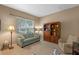 Cozy living room with neutral color palette, comfortable seating, and natural light at 5226 Smokey Water Ln, Oviedo, FL 32765