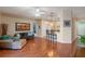 Open-concept living room with wood floors, bar seating, and view to the front entry at 5226 Smokey Water Ln, Oviedo, FL 32765