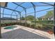 Relaxing screened-in patio featuring a spa, brick pavers and outdoor living space at 5226 Smokey Water Ln, Oviedo, FL 32765