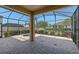 Covered patio with a hot tub, screened enclosure, and stylish brick flooring at 5226 Smokey Water Ln, Oviedo, FL 32765