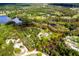 Aerial view of property highlighting the spacious land, home, and surrounded by a greenbelt and serene ponds at 538 Murray St, Osteen, FL 32764