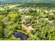 Aerial view of home site surrounded by lush trees and pond at 538 Murray St, Osteen, FL 32764