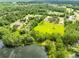 Aerial view of land for sale with picturesque lake and mature trees at 538 Murray St, Osteen, FL 32764
