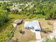 Expansive aerial view showcasing a home with an attached garage and proximity to a charming outdoor space at 538 Murray St, Osteen, FL 32764
