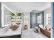 Modern bathroom featuring dual vessel sinks, a glass-enclosed shower, and a soaking tub at 538 Murray St, Osteen, FL 32764