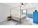 Stylish bedroom with a unique four-poster bed, blue dressers, and decorative ceiling fan at 538 Murray St, Osteen, FL 32764