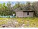 A quaint exterior with boarded window and unkempt yard at 538 Murray St, Osteen, FL 32764