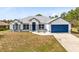 Charming single-story home featuring a well-maintained lawn, blue accents, and an attached garage at 538 Murray St, Osteen, FL 32764
