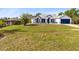 Beautiful home with blue trim and a blue garage door sits on a large lot, offering plenty of space for outdoor activities at 538 Murray St, Osteen, FL 32764