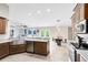 Bright and airy kitchen features stainless steel appliances, granite countertops, and a view of the open-concept living space at 538 Murray St, Osteen, FL 32764