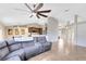 Open-concept living room and kitchen, perfect for entertaining, featuring modern decor, large sectional, and island seating at 538 Murray St, Osteen, FL 32764