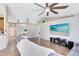 Inviting living room with large TV, fireplace, and plush sectional, creating a comfortable and stylish space for relaxation at 538 Murray St, Osteen, FL 32764